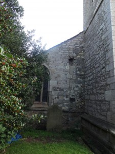 The family tombstone tucked away in a back corner with a couple of odd looking gargoyles above it