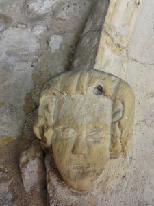 Face on the left hand side of the entrance door