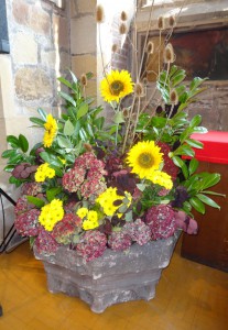Cheerful flowers. I have found flowers in country churches to be rustic but cheerful and attractive.