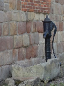 Remains of an old water pump beside the old hall.