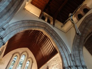 New crucifix hanging in the location of the original rood screen with gold crucifix which had been an object of veneration but was removed during the reformation. 