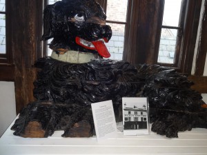 The carved wooden dog from a demolished pub. it was found by chance.