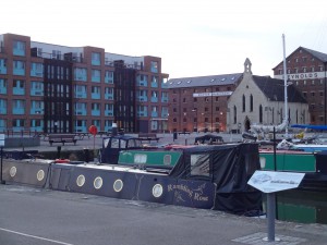 More narrow boats, warehouses, modern housing and the mariners church.