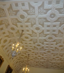 Enormous room with an ornate ceiling and numerous portraits of previous inhabitants 
