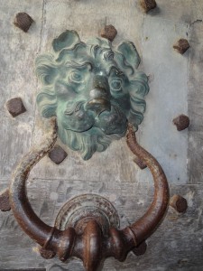 Rather benign looking lion on an iron studded door